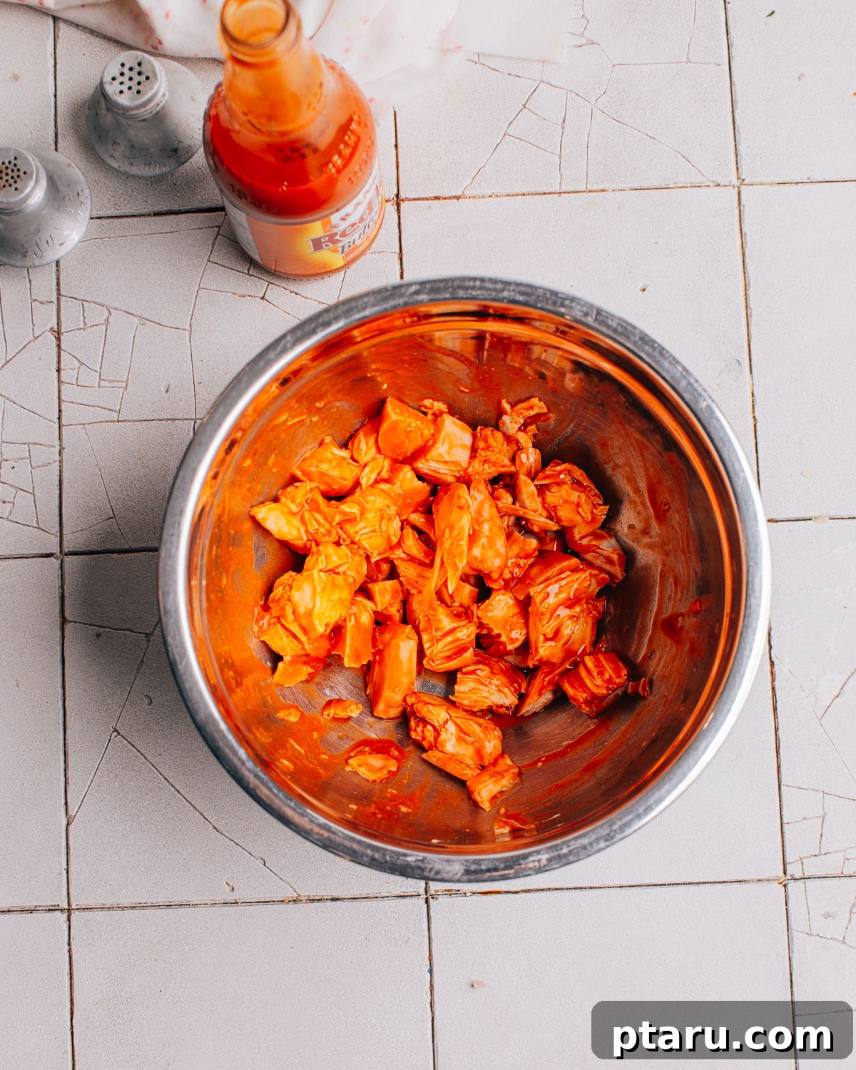 Zingy Buffalo Chicken Pasta Medley 5 Preparing the creamy blue cheese dressing in a bowl, showing sour cream, mayonnaise, and other ingredients being whisked.