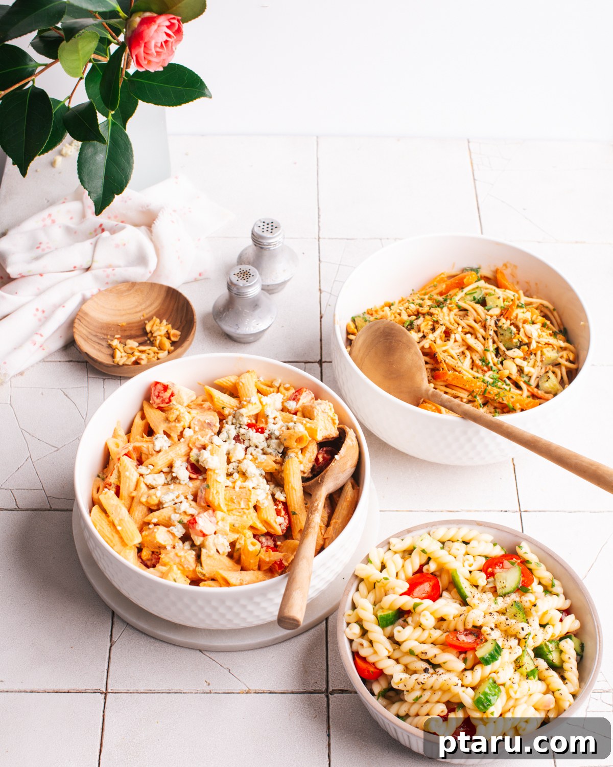 Zingy Buffalo Chicken Pasta Medley 8 A close-up of the Buffalo Chicken Pasta Salad, highlighting the texture of the pasta, the shredded chicken, and the vibrant bits of celery and tomato, all coated in the creamy dressing.