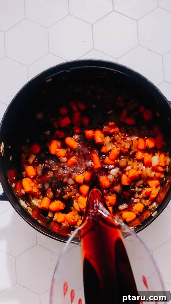 Rustic Dutch Oven Beef Stew 6 Deglazing with wine.