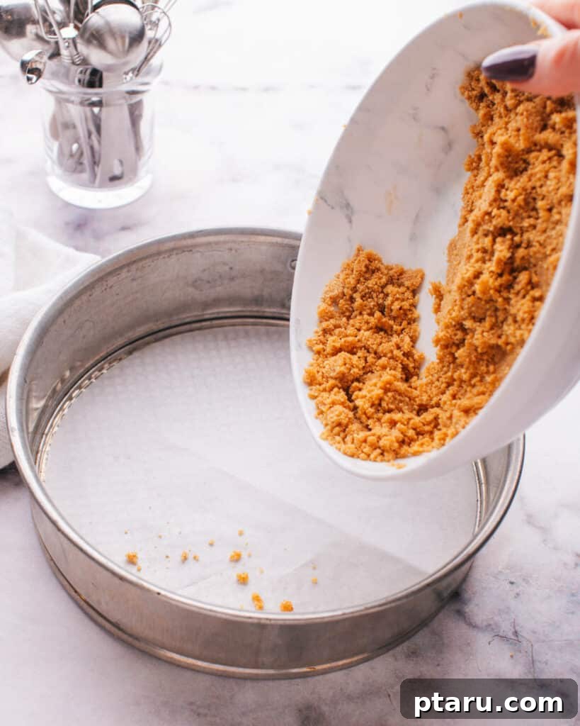 Perfect Graham Cracker Crust 8 Transferring the graham cracker mixture into a prepared springform pan.