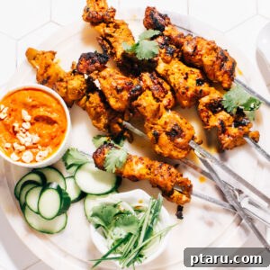 Thai Satay skewers with peanut sauce on a plate.