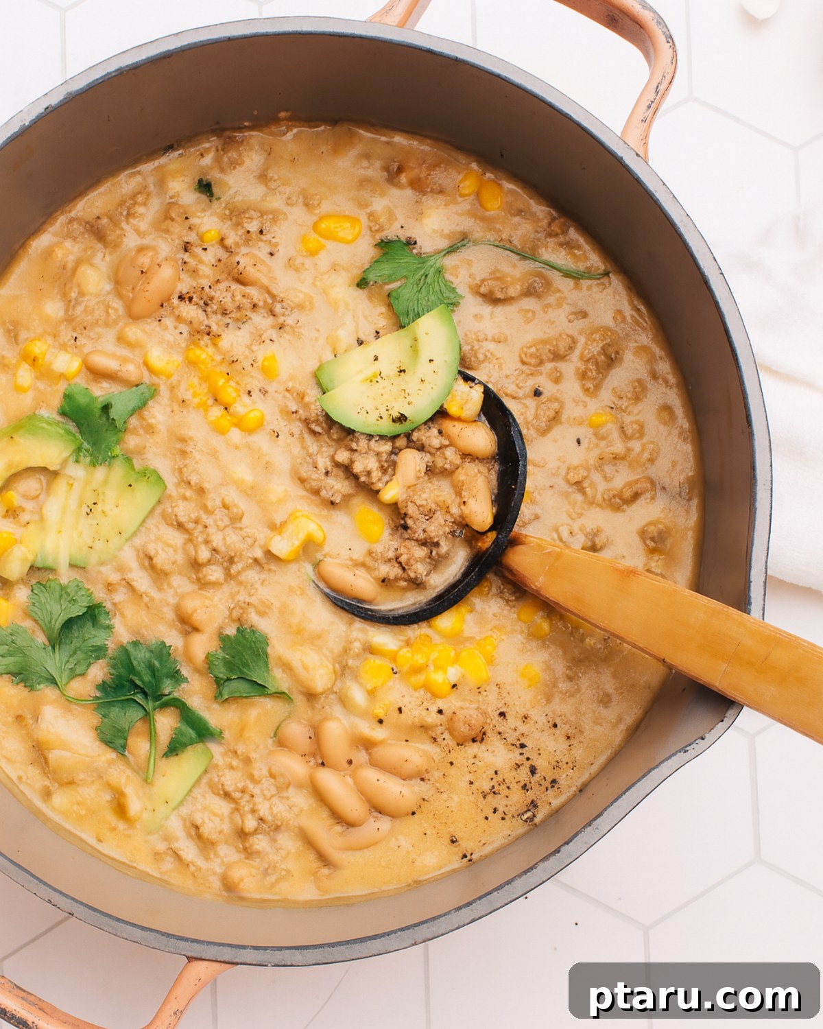 Hearty Turkey White Bean Chili 5 Creamy White Bean Turkey Chili simmering in a large pot, ready to be served.