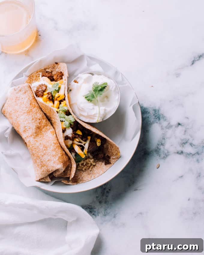 Cheesy Beef and Rice Meal Prep Burritos 2 Delicious ground beef burritos wrapped in foil, ready for freezing.