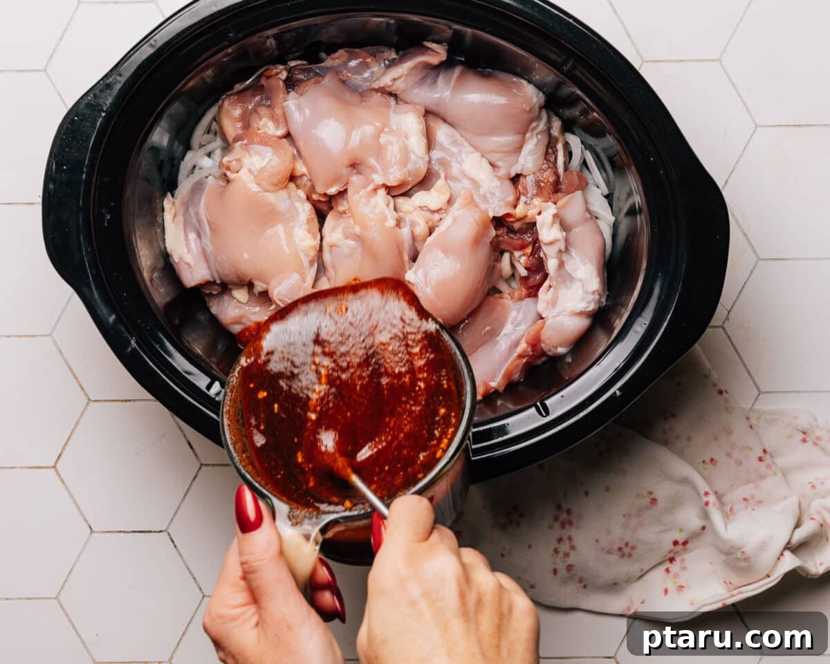Effortless Slow Cooker BBQ Chicken 6 Ingredients for BBQ sauce being whisked in a bowl.