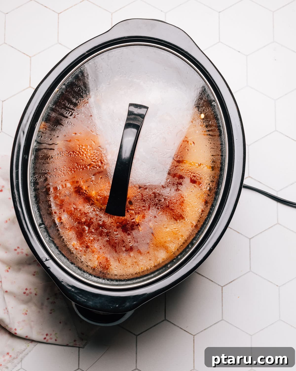 Effortless Slow Cooker BBQ Chicken 7 BBQ sauce being poured over chicken in the crockpot.