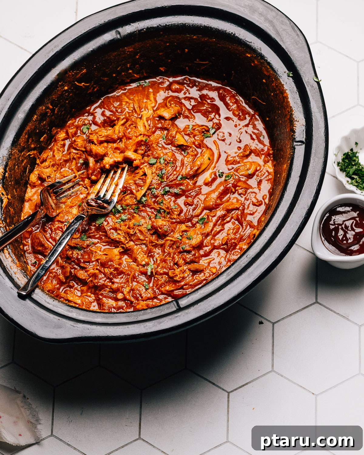 Effortless Slow Cooker BBQ Chicken 9 Shredded BBQ chicken coated in sauce, ready to serve.