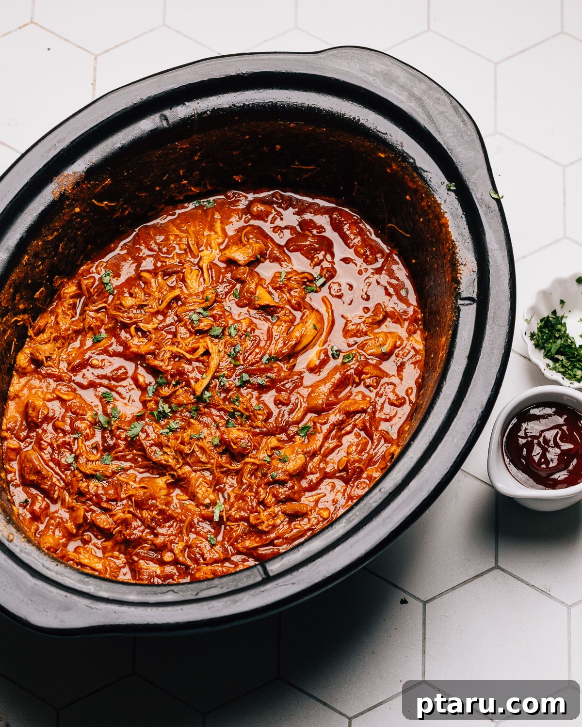 Effortless Slow Cooker BBQ Chicken 10 Crockpot BBQ Chicken simmering in the slow cooker insert, ready to be served.