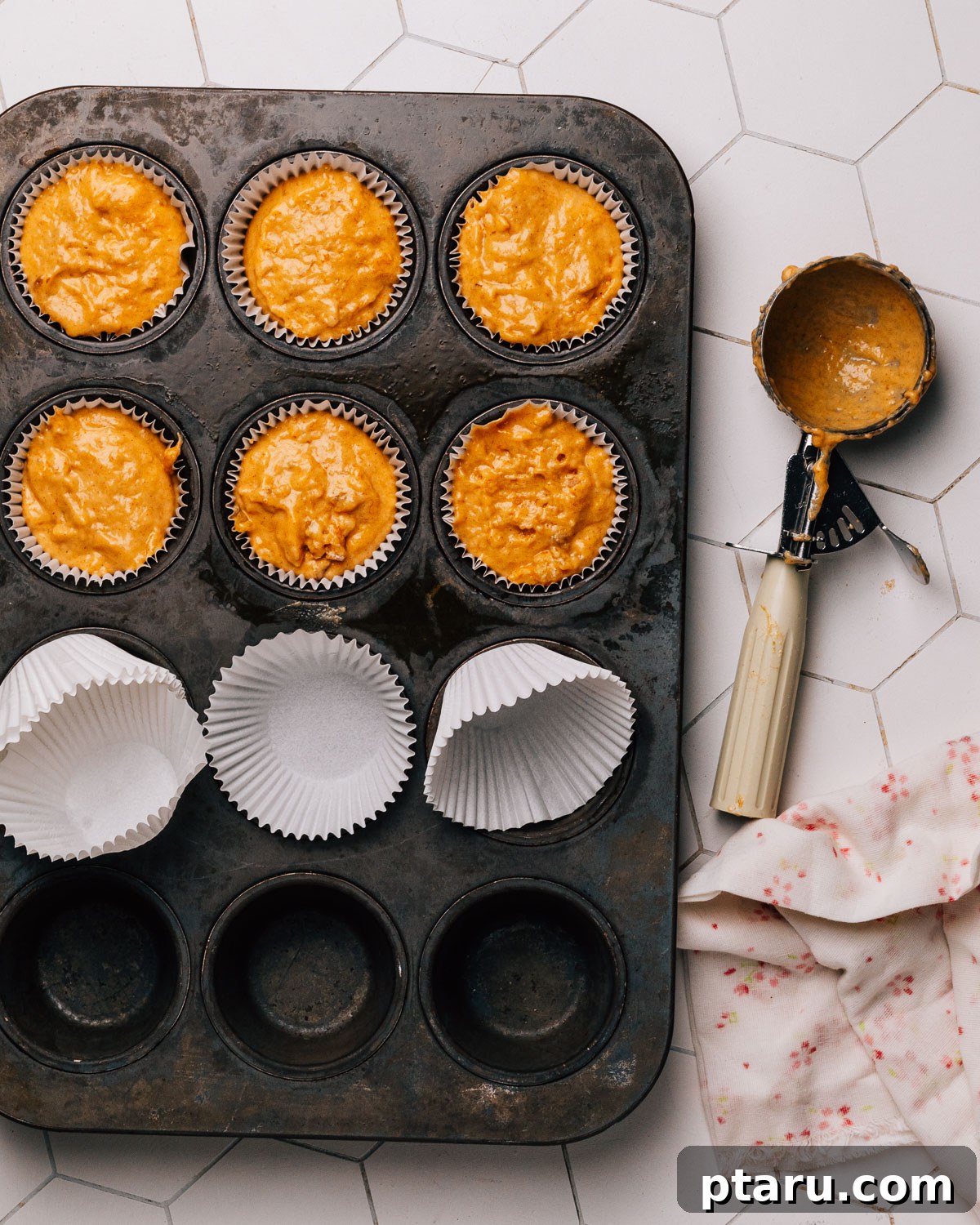 Spiced Pumpkin Banana Muffins 7 Pumpkin banana muffin batter scooped into baking liners.