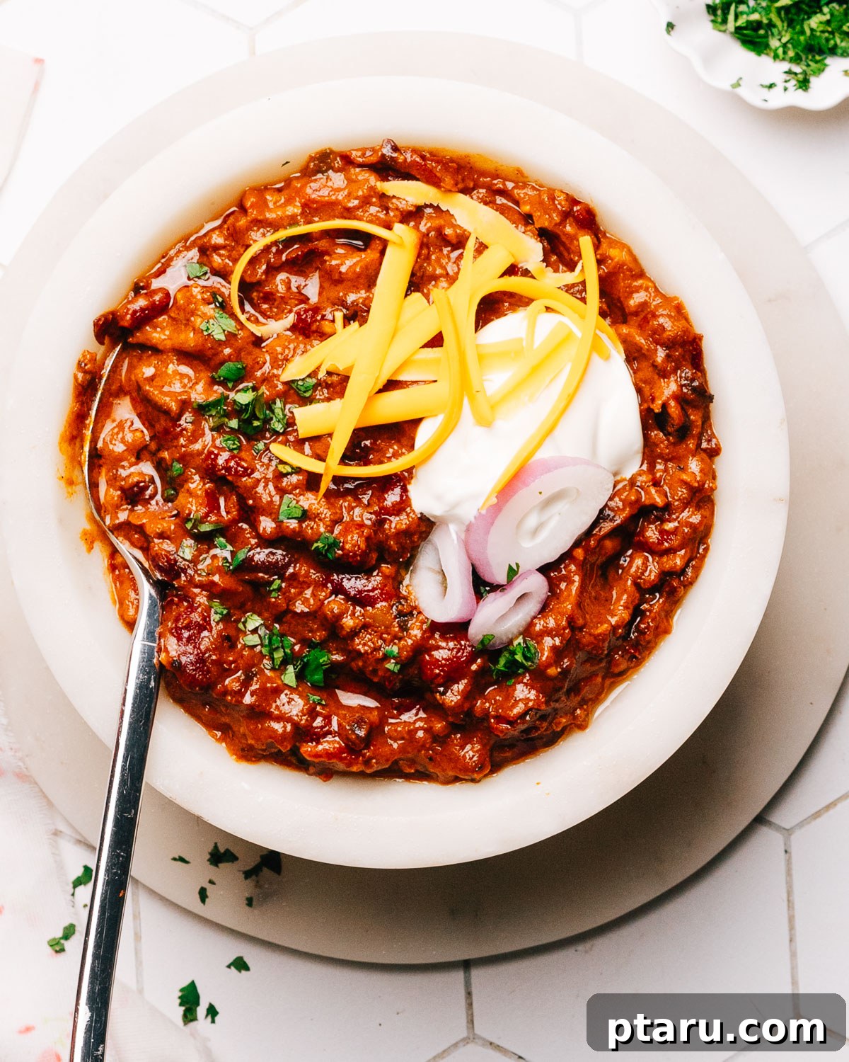 Hearty Instant Pot Chili 2 A steaming bowl of rich Instant Pot Chili, garnished and ready to be enjoyed.