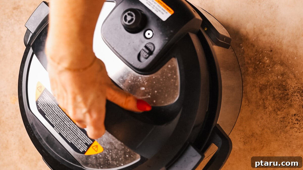 Hearty Instant Pot Chili 4 An Instant Pot lid being closed and sealed, ready for pressure cooking.