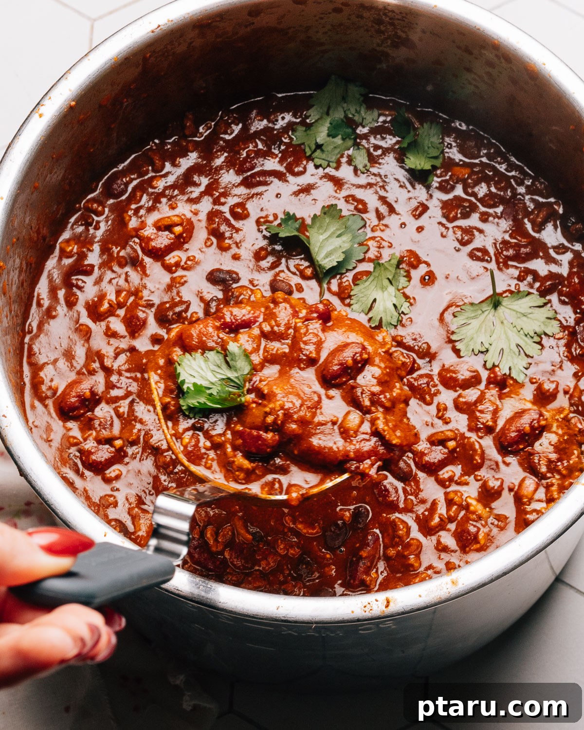 Hearty Instant Pot Chili 5 A large pot of Instant Pot Chili with a ladle, ready to be served.
