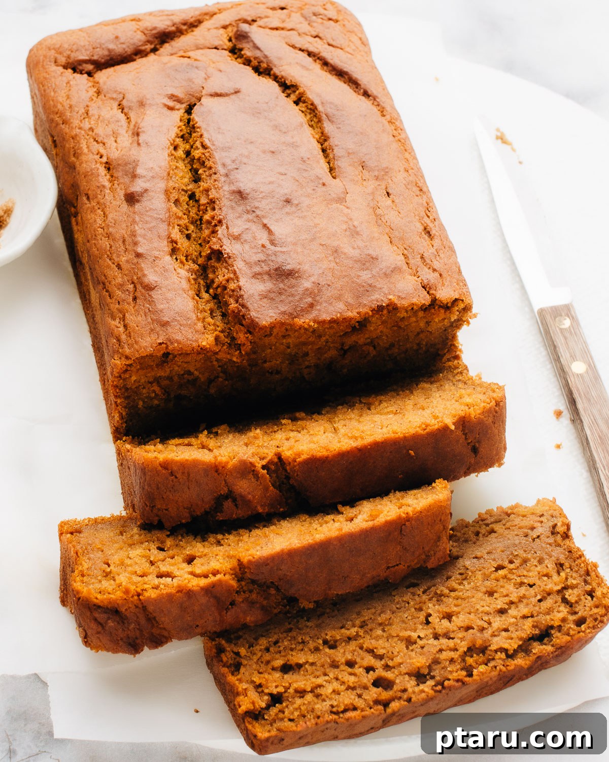 Soft and Moist Pumpkin Banana Bread 2 A freshly baked loaf of moist pumpkin banana bread, perfectly golden brown and ready to slice.