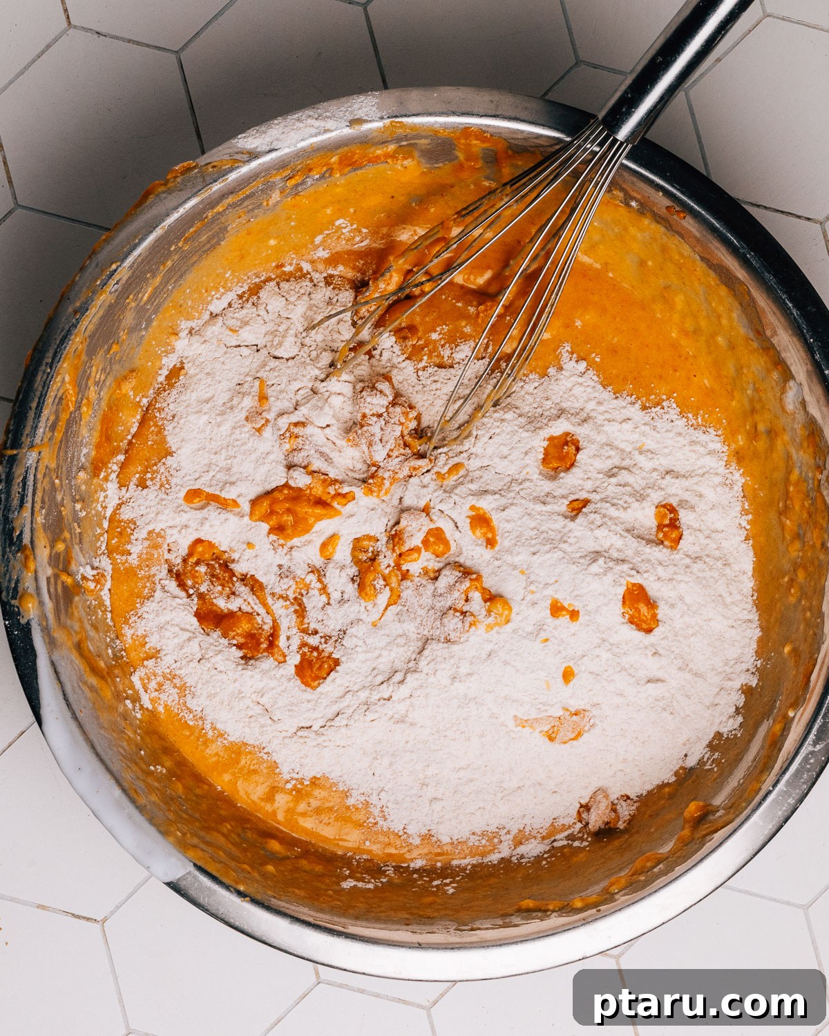 Soft and Moist Pumpkin Banana Bread 6 Step 2: Dry ingredients for pumpkin banana bread being whisked in a separate bowl.