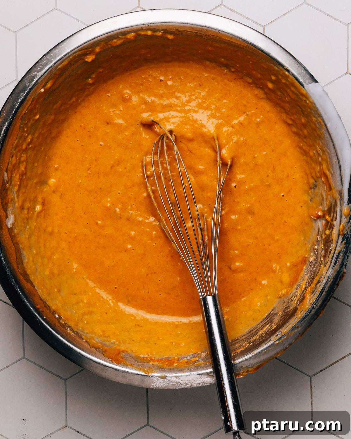 Soft and Moist Pumpkin Banana Bread 7 Step 3: Wet and dry ingredients being combined for pumpkin banana bread batter.
