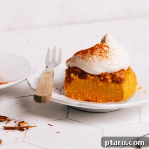 Pumpkin Dump Cake dessert recipe topped with whipped cream.