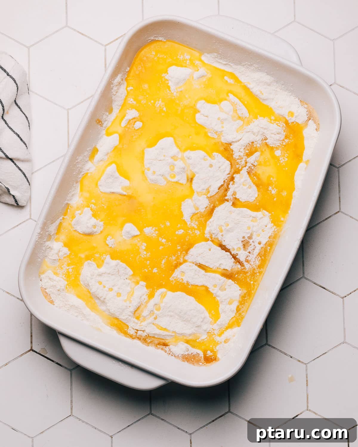 Effortless Autumn Pumpkin Bake 7 Step 4: Drizzling melted butter over the cake mix layer before baking.