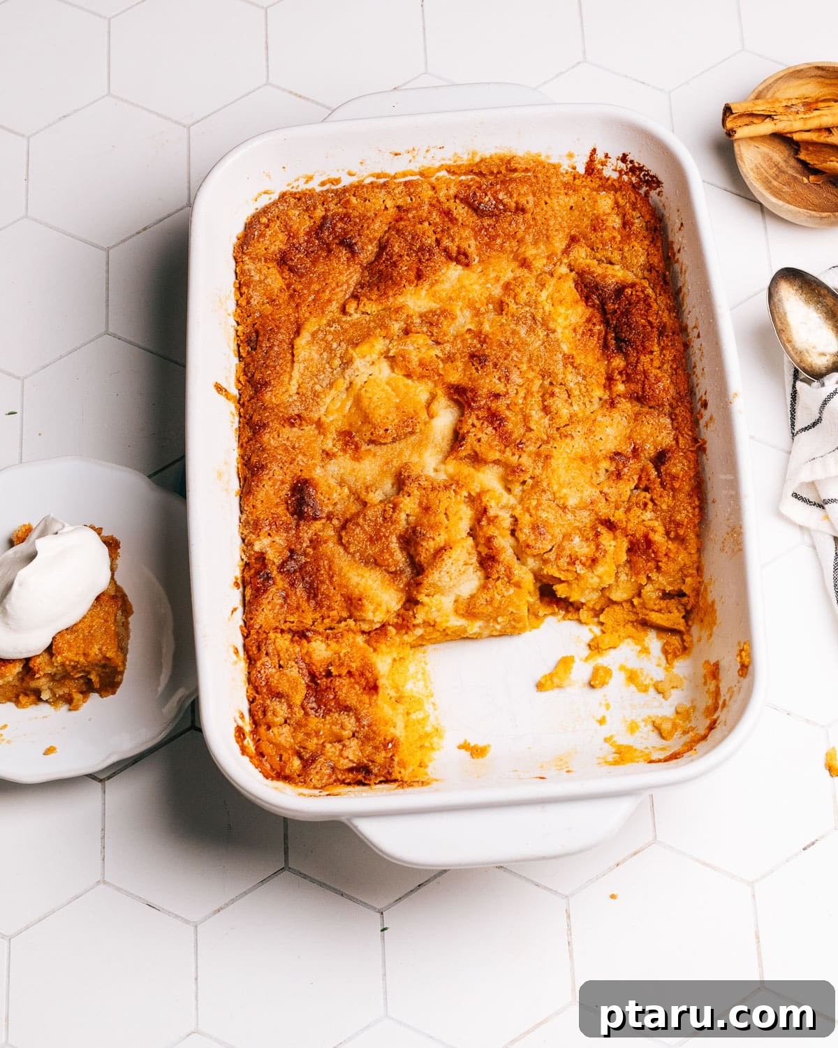 Effortless Autumn Pumpkin Bake 8 A whole Pumpkin Dump Cake cooling on a wire rack after baking, showcasing its golden-brown, streusel-like topping.
