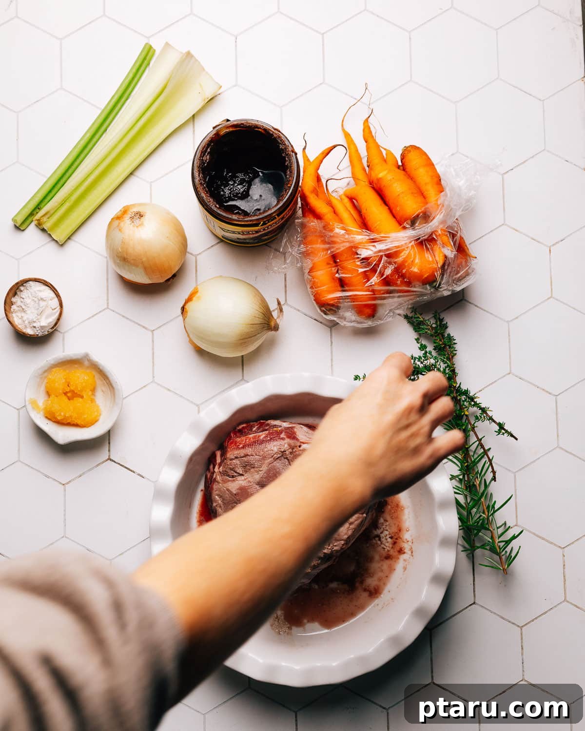 Perfect Pot Roast with Rich Gravy 3 A curated selection of fresh ingredients for beef chuck roast, including beef, vegetables, and herbs.