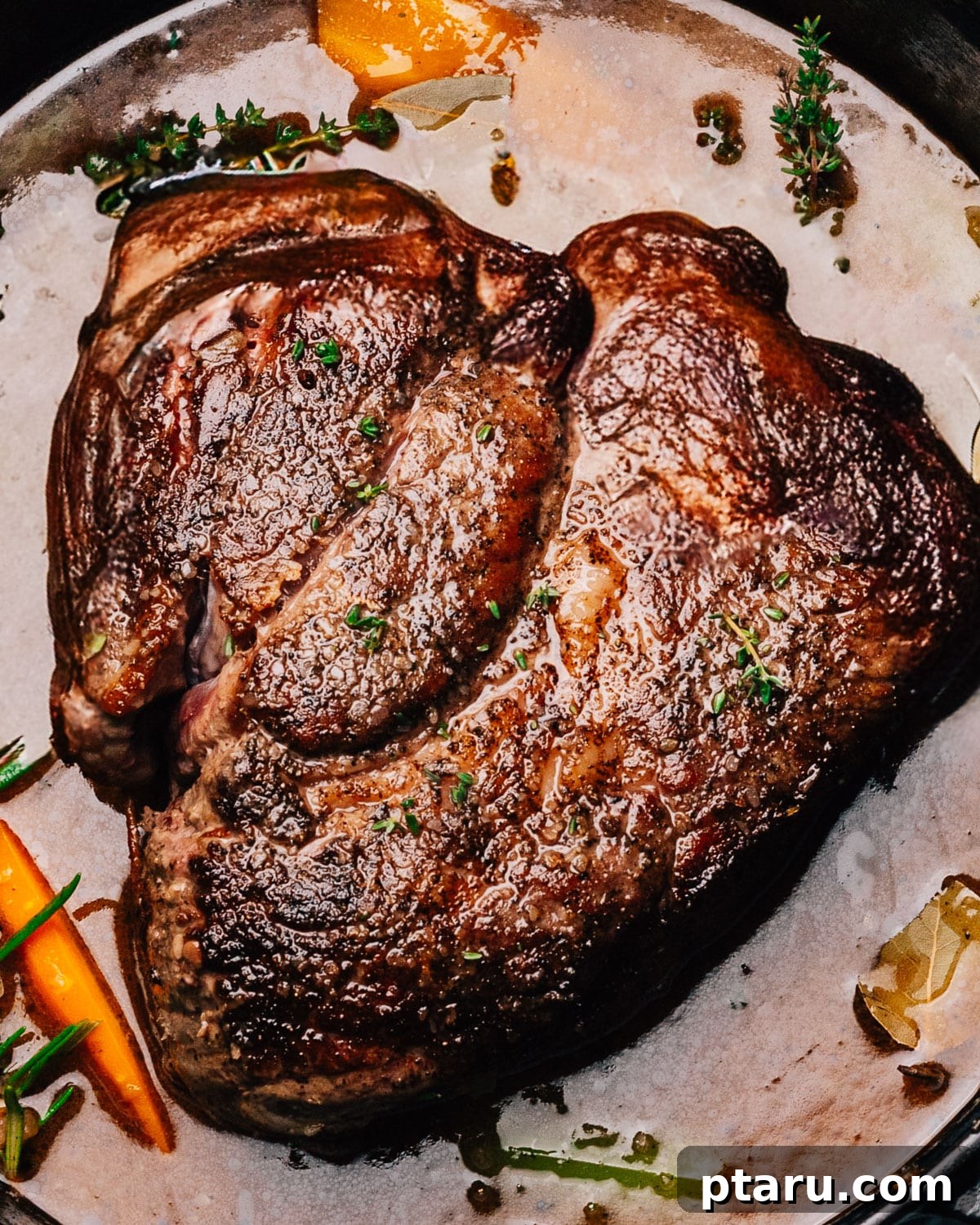 Perfect Pot Roast with Rich Gravy 7 Beef chuck roast simmering gently in braising liquid in a Dutch oven before going into the oven.