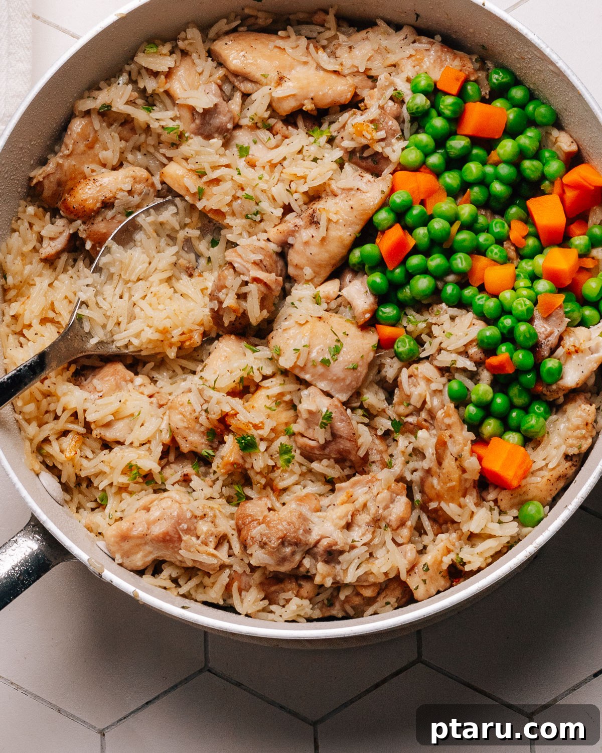 Savory One-Pot Chicken and Rice 11 A close-up shot of the finished chicken and rice dish, garnished with fresh parsley, highlighting the fluffy rice and tender chicken.