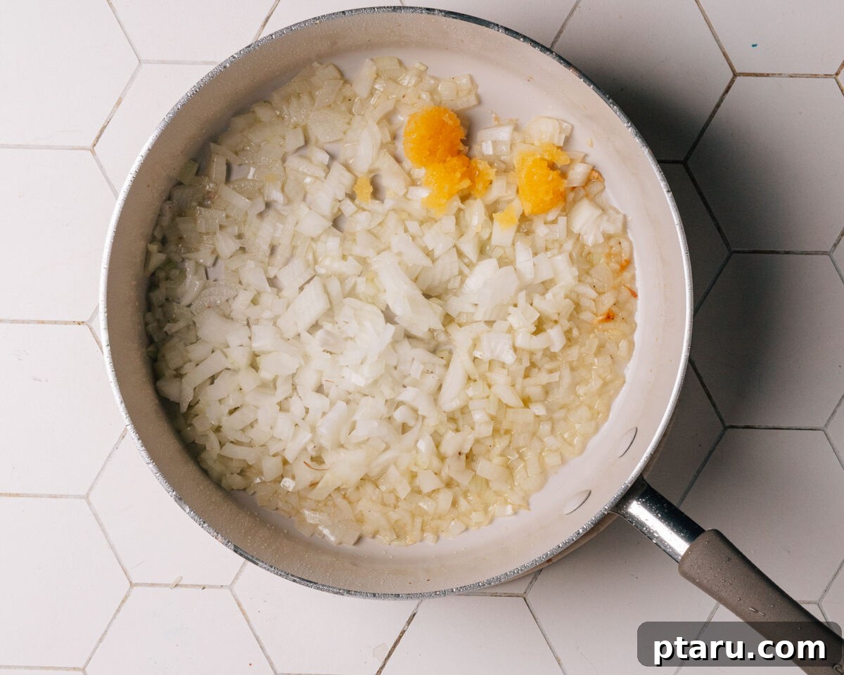 Savory One-Pot Chicken and Rice 5 Finely chopped onions and minced garlic cooking in the skillet, absorbing the chicken's flavorful fond.