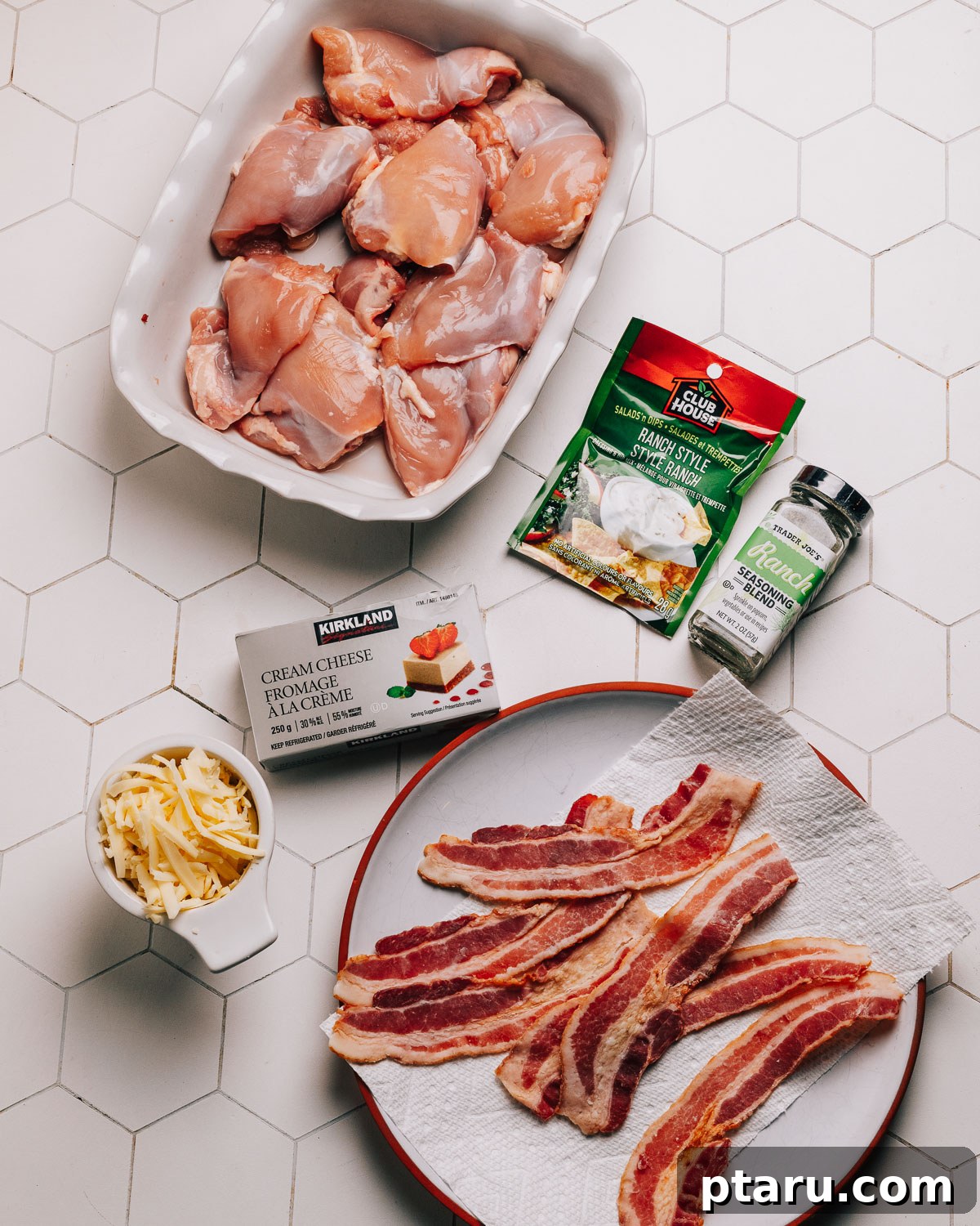 Seriously Addictive Ranch Chicken 3 Individual ingredients for Crack Chicken recipe laid out: chicken, ranch seasoning, cream cheese, cheddar cheese, bacon, green onions.