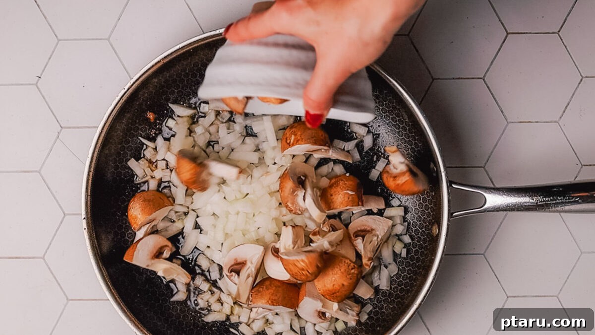 Melt-in-Your-Mouth Slow Cooker Beef Tips and Gravy 5 Step 2: Sautéing chopped onions and cremini mushrooms in the same skillet to build flavor.