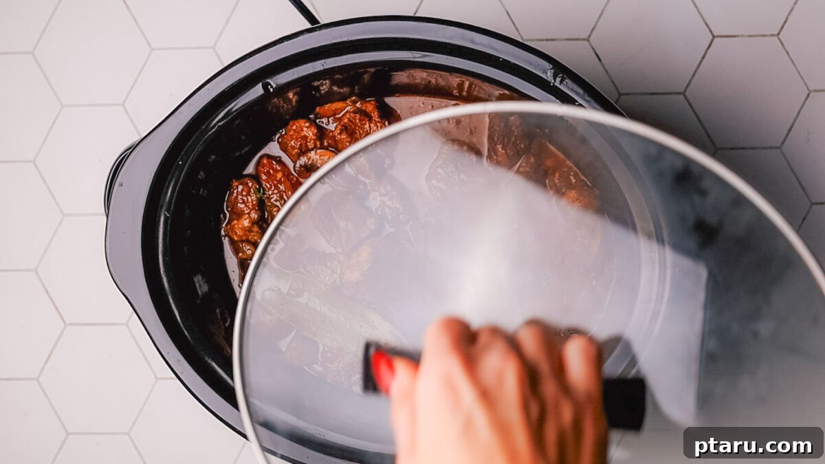 Melt-in-Your-Mouth Slow Cooker Beef Tips and Gravy 8 Step 5: Thickening the rich gravy with a cornstarch slurry at the end of cooking.