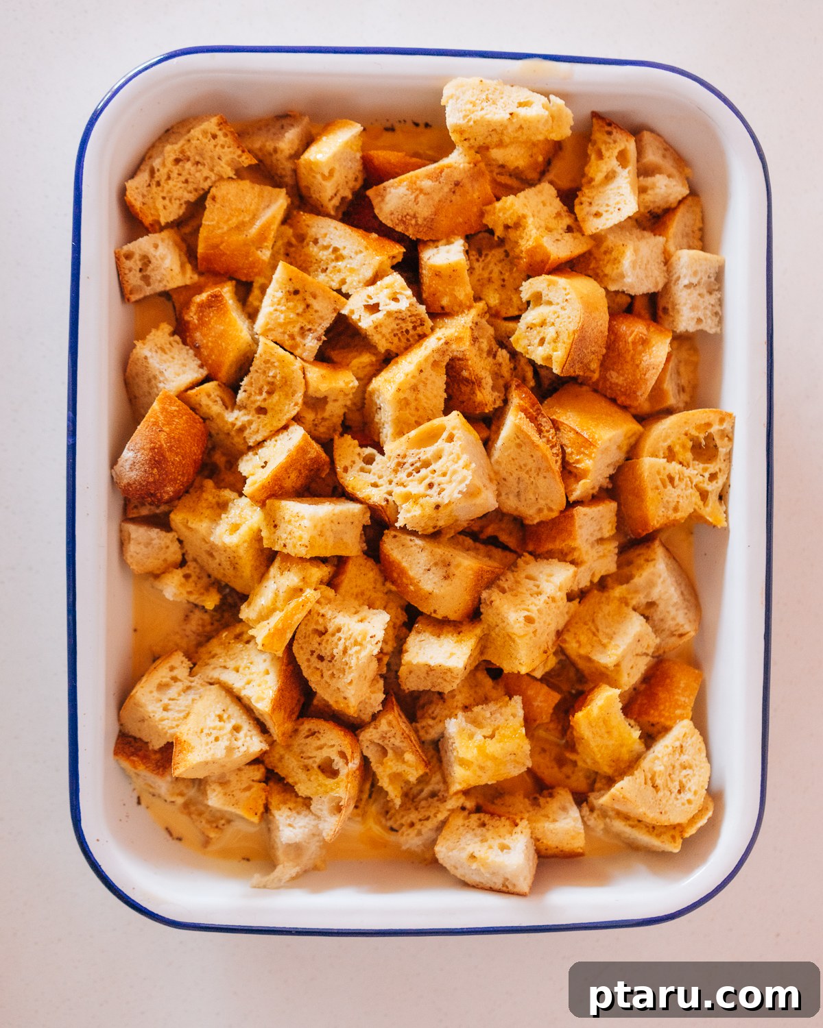Overnight French Toast Bake for Easy Mornings 5 Step 2: Whisking the egg and milk custard mixture in a large bowl.