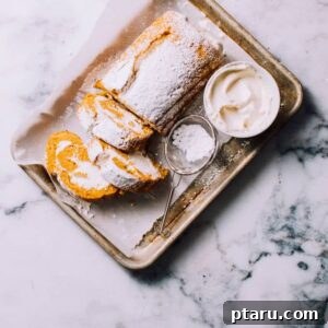 A perfectly prepared Spiced Pumpkin Roll, beautifully showcasing its intricate spiral layers and luscious, creamy filling, an elegant fall dessert.