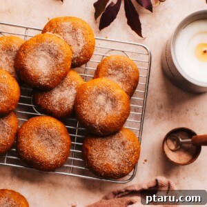 A charming fall tablescape featuring a plate of freshly baked Soft Pumpkin Cookies, invitingly arranged and ready to be savored.