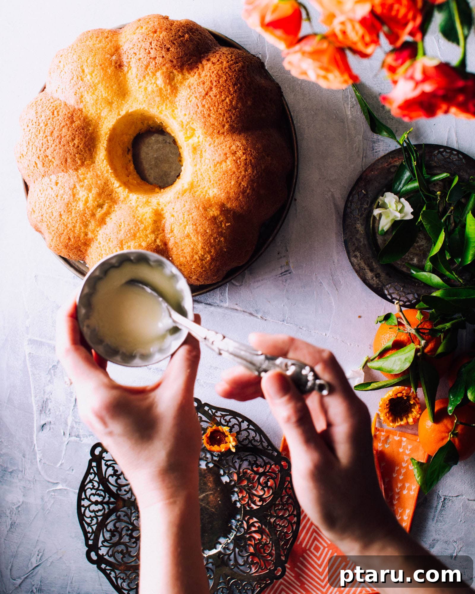Zesty Orange Pound Cake with Citrus Glaze 3 Close-up of a perfectly baked orange pound cake adorned with delicate flowers, highlighting its rich color and tender crumb.