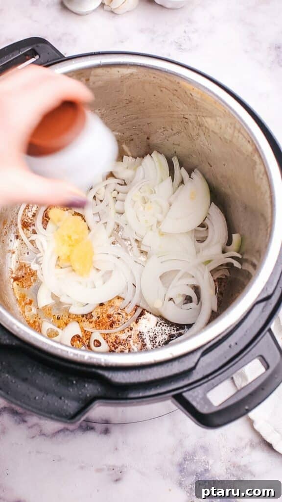 Hearty Instant Pot Beef Barley Soup 4 Adding chopped onion to the Instant Pot