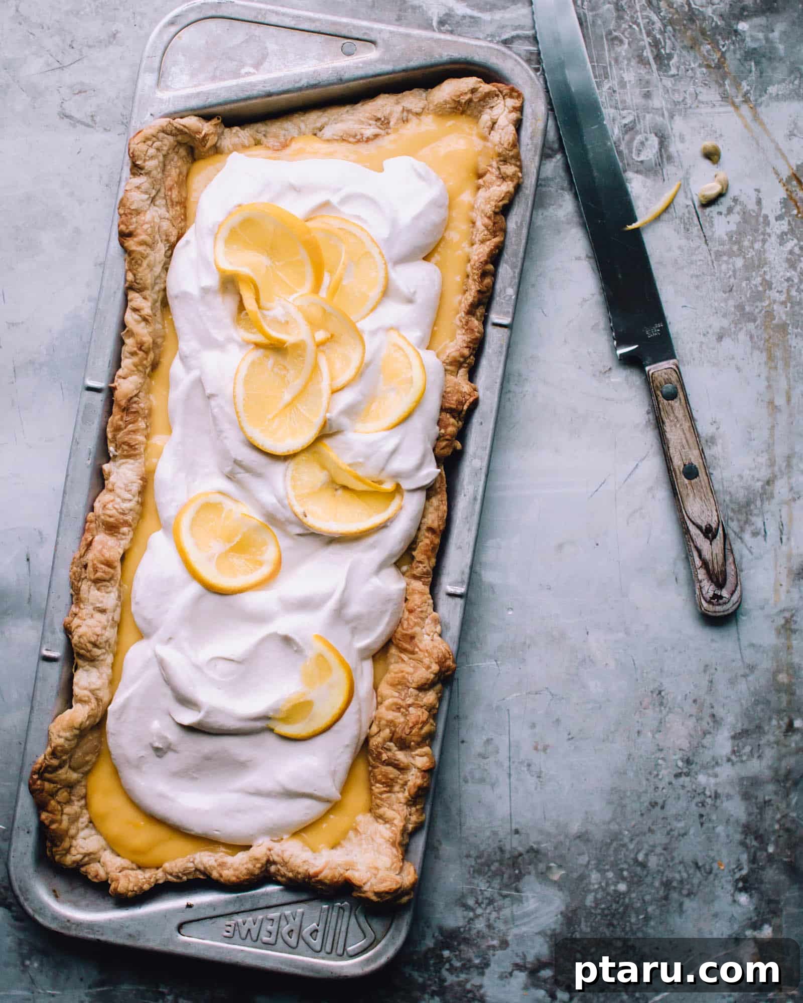 Sunshine Lemon Tart 2 Easy Lemon Tart in a pan, showcasing its golden crust and creamy filling.