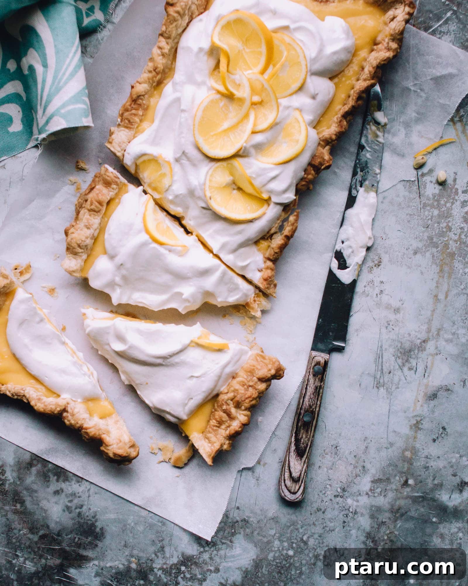 Sunshine Lemon Tart 4 Easy Lemon Tart sliced on parchment paper, ready to be served.