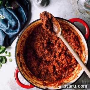 Ultimate Rich and Easy Meat Sauce 3 Meat Sauce in a pot with a spoon.