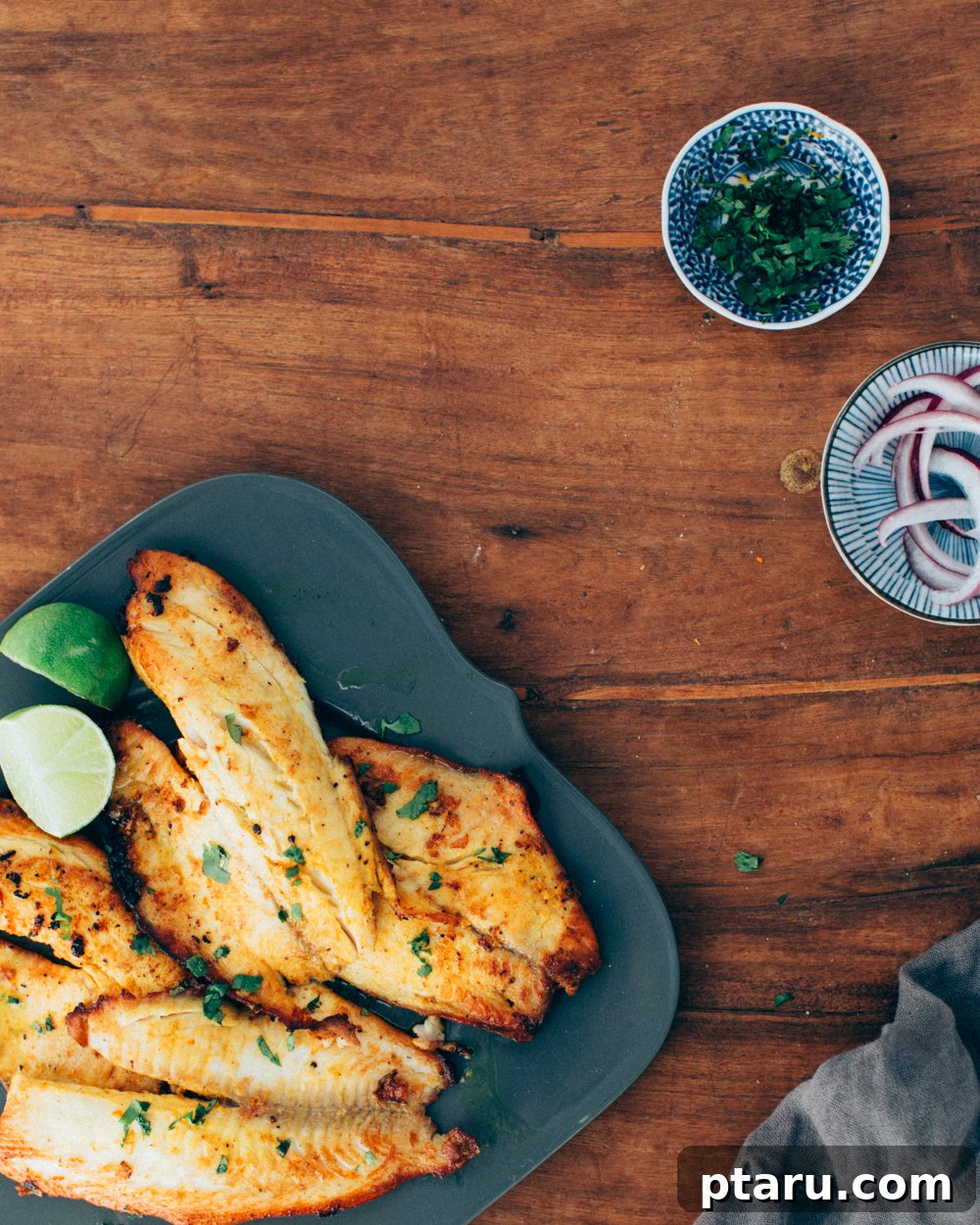 Spicy Kerala Fish Fry 2 Indian fried fish recipe with onions and cilantro, showcasing perfectly pan-fried fish.