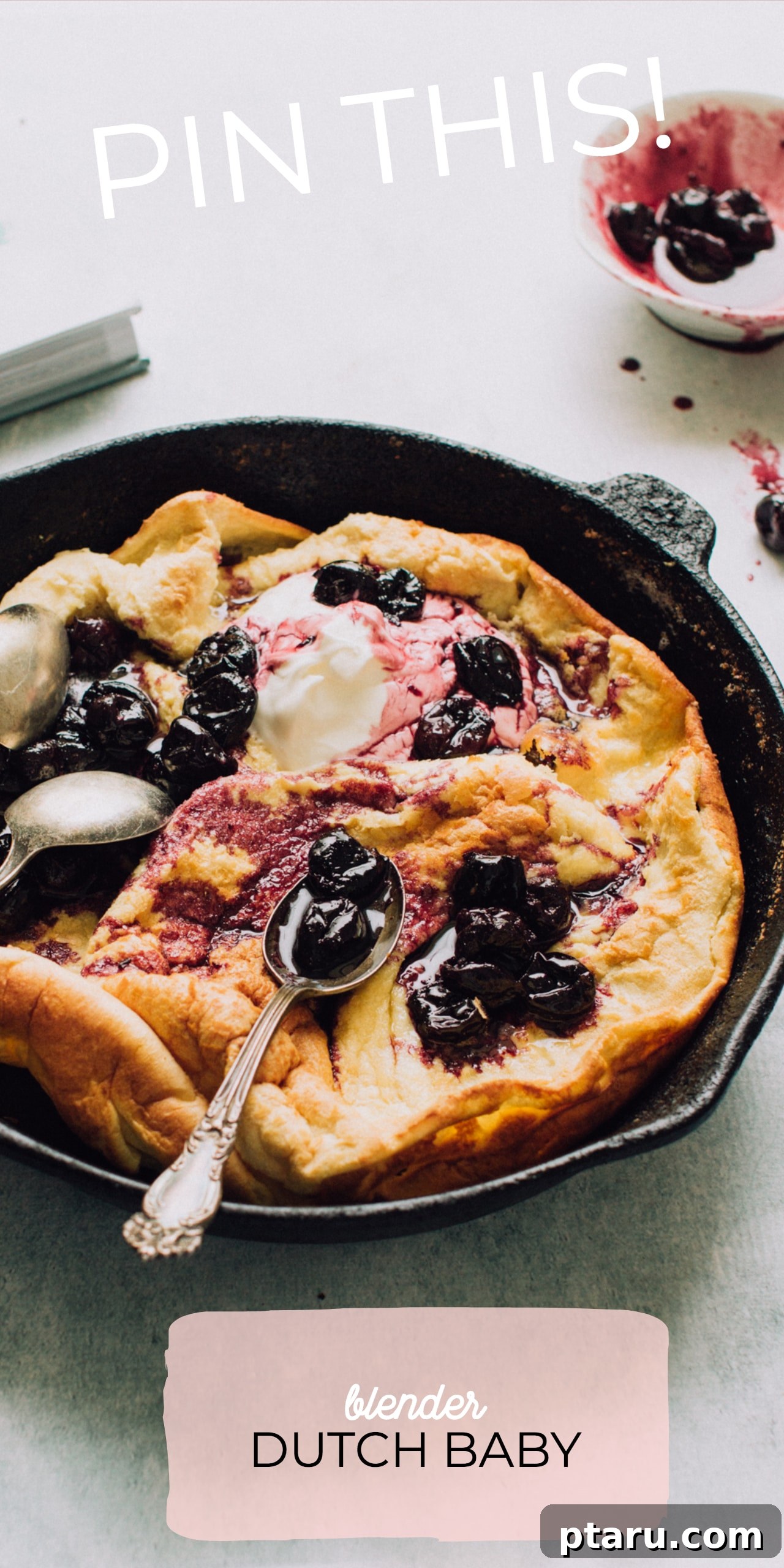 Effortless Blender Dutch Baby 3 Close-up of a golden-brown Blender Dutch Baby served with a dollop of yogurt and sweet stewed tart cherries.