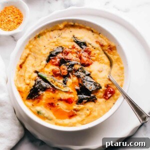 Spiced Masoor Dal Curry 9 Masoor dal (red lentil curry) with tarka in a bowl with a spoon.