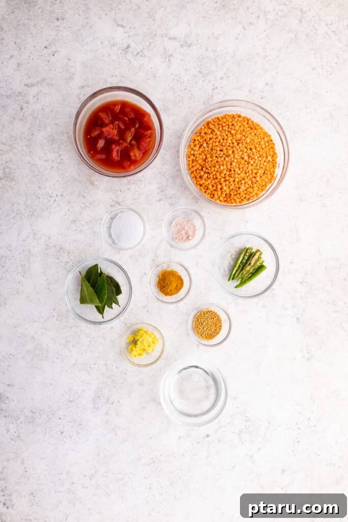 Spiced Masoor Dal Curry 3 Fresh ingredients for Masoor Dal laid out on a wooden board.