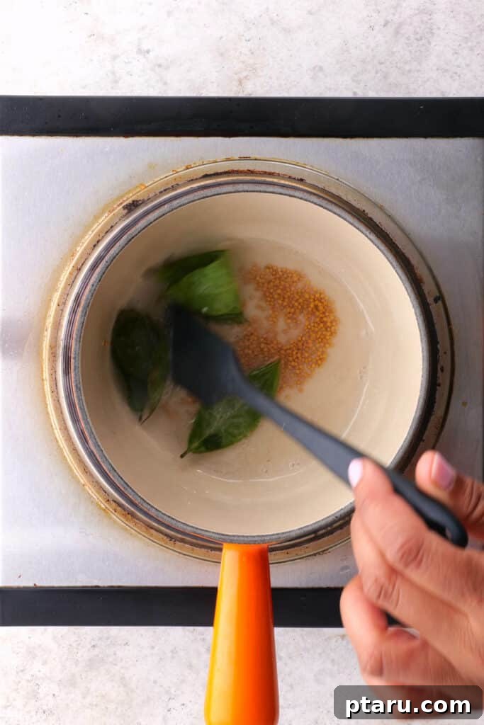 Spiced Masoor Dal Curry 5 Sautéing the spices to create the dal tadka, with mustard seeds and curry leaves visible.
