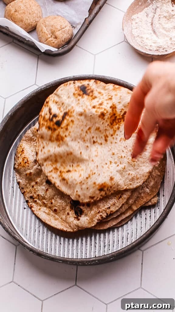 Spiced Masoor Dal Curry 7 Soft, freshly made roti bread in a serving dish.