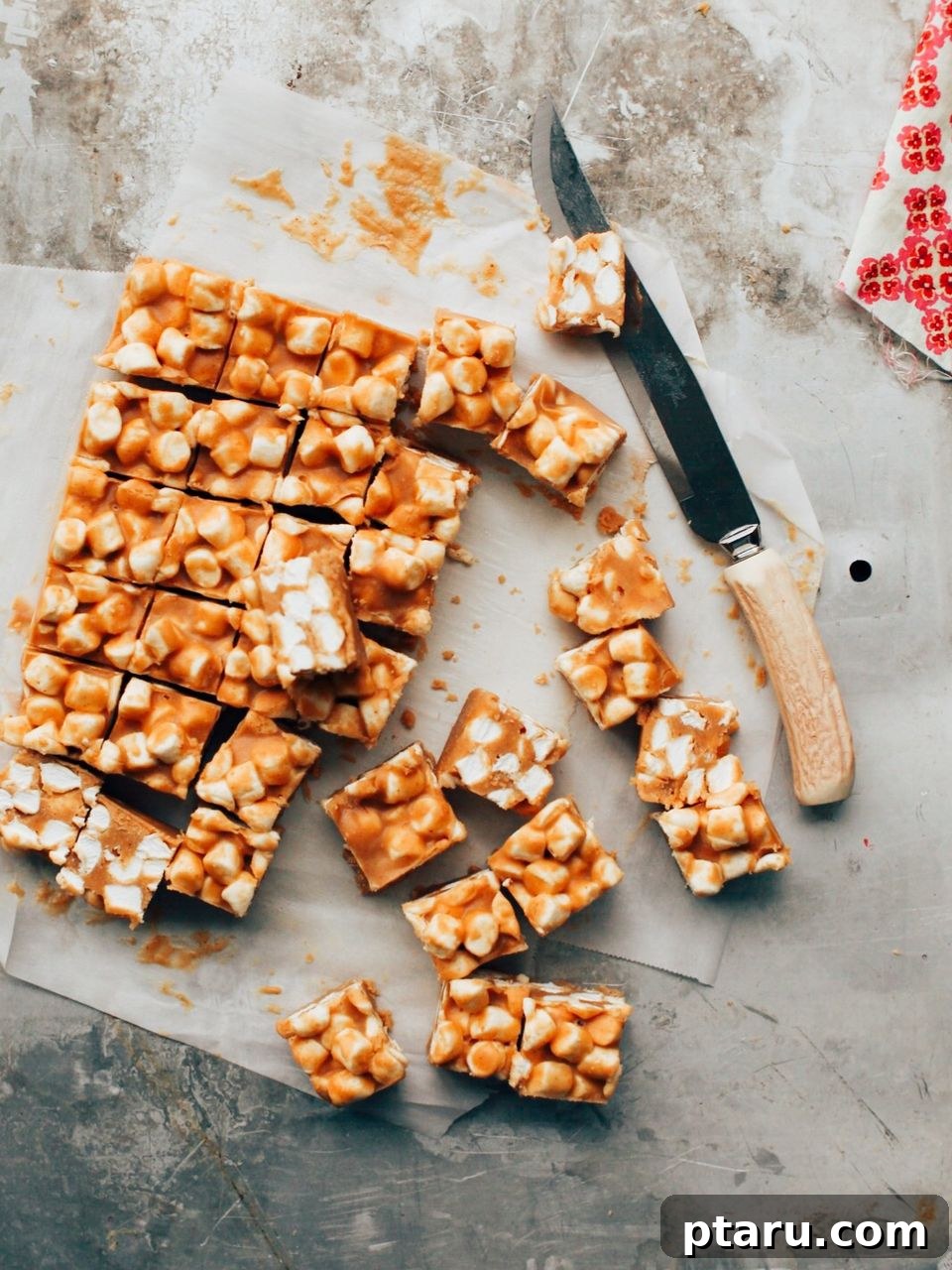 Golden Confetti Peanut Butter Squares 2 Peanut butter marshmallow bars cut into squares on a sheet, showcasing their colorful marshmallow flecks.