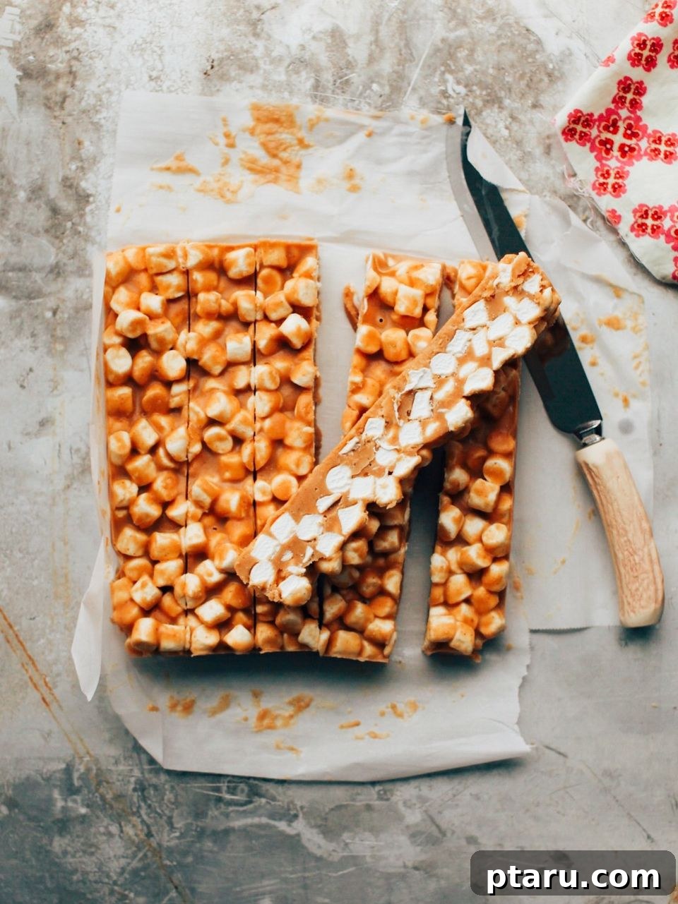 Golden Confetti Peanut Butter Squares 3 Peanut butter marshmallow butterscotch treats cut into strips, ready for final slicing into individual squares.