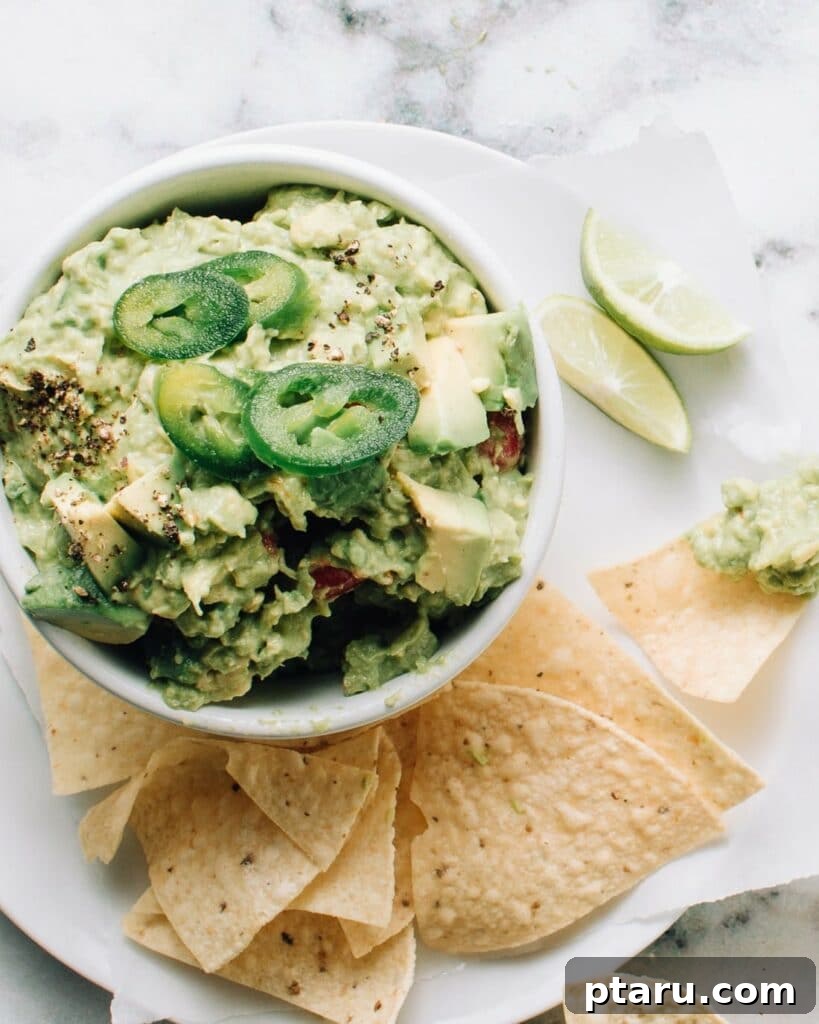 Authentic Mexican Ground Beef Tacos 9 Authentic Mexican guacamole in a bowl, topped with fresh jalapeños and cilantro