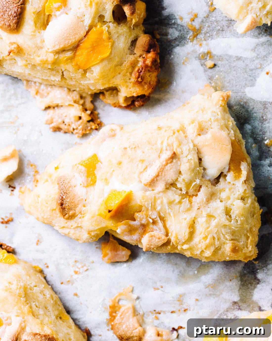 Sun-Kissed Flaky Mango White Chocolate Scones 2 Flaky buttermilk scones with mango and white chocolate chips, fresh out of the oven.