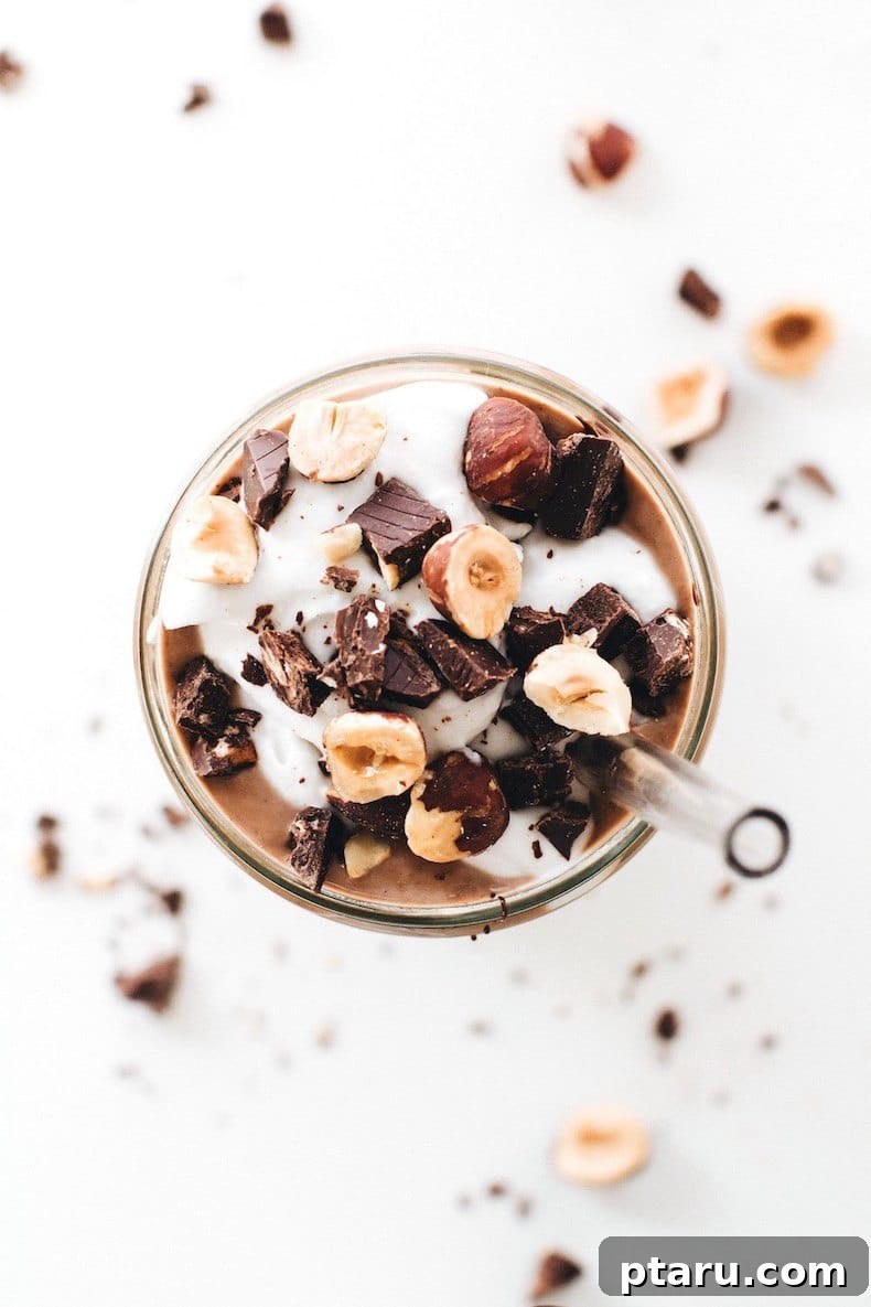 25+ Game-Changing Healthy Smoothie Recipes 23 An inviting overhead view of a creamy chocolate hazelnut smoothie, garnished beautifully, hinting at a luxurious and flavorful blend.