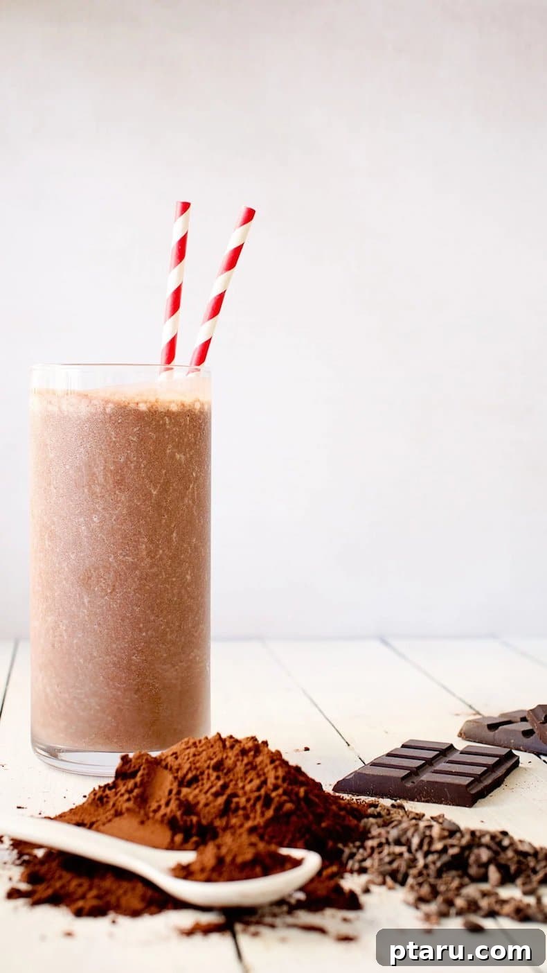 25+ Game-Changing Healthy Smoothie Recipes 24 A rich chocolate smoothie, beautifully garnished with a sprinkle of cocoa powder and dark chocolate pieces, highlighting its indulgent and wholesome ingredients.