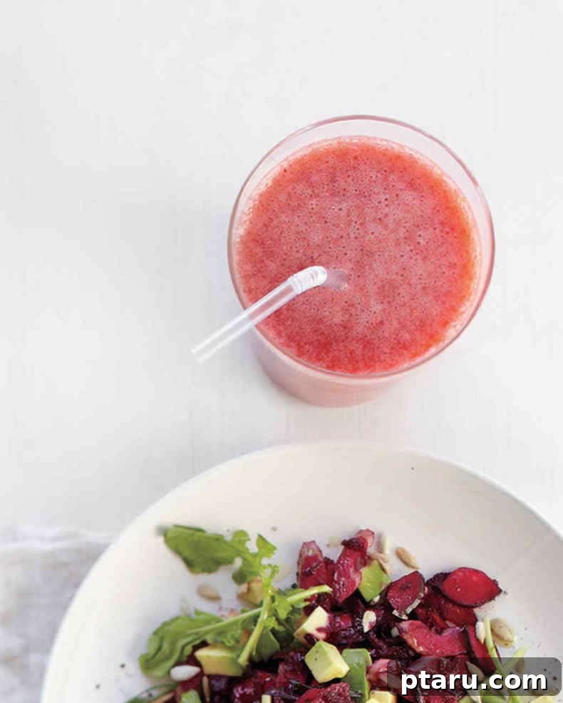 25+ Game-Changing Healthy Smoothie Recipes 7 A vibrant strawberry grapefruit smoothie served alongside a crisp salad, offering a refreshing and healthy meal combination.