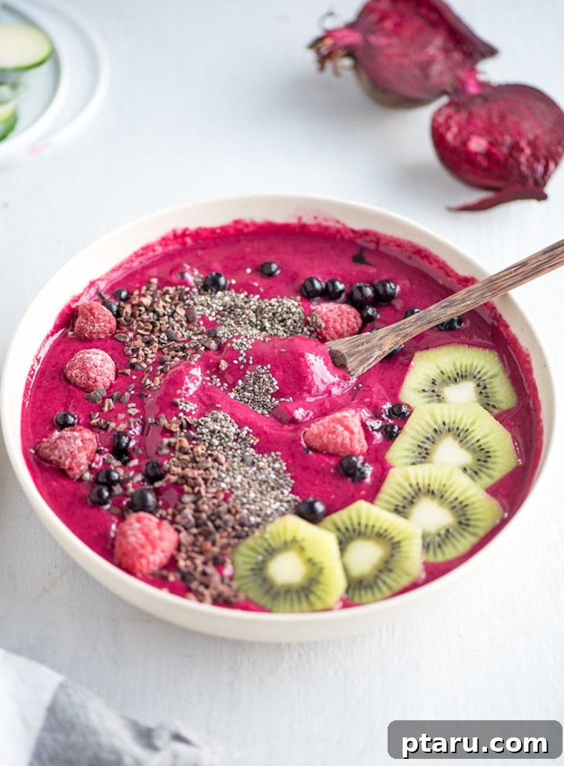 25+ Game-Changing Healthy Smoothie Recipes 8 A colorful strawberry beet smoothie bowl, beautifully topped with fresh kiwi slices, showcasing a vibrant and healthy breakfast or snack.
